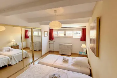 a bedroom with two beds and a mirror at HENRI CAMILLE REAL ESTATE - ROOF - 2 bedrooms downtown w rooftop in Cannes