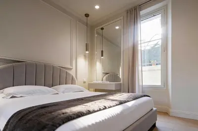 a bedroom with a large bed with a large window at Modern AC apartment - 2BDR 4P - Cannes Beach in Cannes