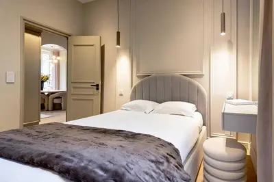 a bedroom with a large white bed and a bathroom at Modern AC apartment - 2BDR 4P - Cannes Beach in Cannes