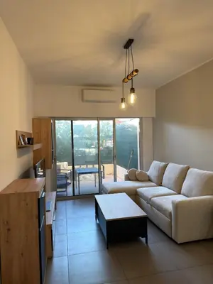 a living room with a couch and a table at Superbe Appartement 2 pièces - 39m2 in Cannes