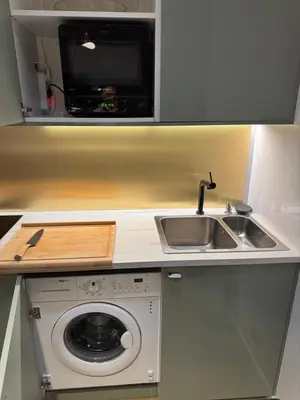 a kitchen with a sink and a washing machine at Très Bel appartement proche plage et palais du festival in Cannes