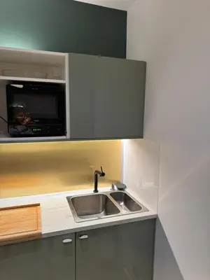 a kitchen with a sink and a microwave at Très Bel appartement proche plage et palais du festival in Cannes