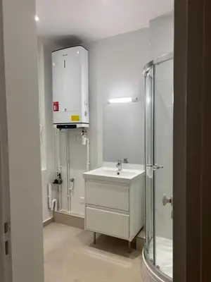 a white bathroom with a sink and a shower at Très Bel appartement proche plage et palais du festival in Cannes