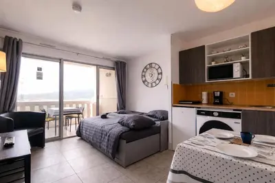 a large building with a swimming pool in front of a building at Panoramic Seaview 2 min walk to the Beach - A&H Homes in Cannes