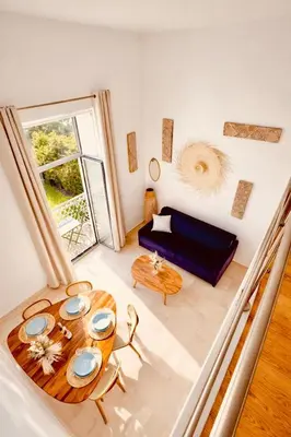 a living room with a table and a couch at Loft suite Cannes Near Palais de festivals in Cannes
