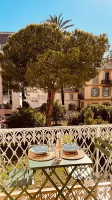 a living room with a couch and a table at Loft suite Cannes Near Palais de festivals in Cannes
