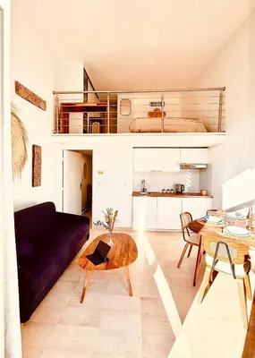 a bedroom with a bed and a mirror on the wall at Loft suite Cannes Near Palais de festivals in Cannes