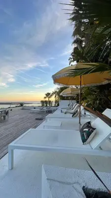 a group of chairs and umbrellas next to a pool at Villa Baie Des Iles in Cannes