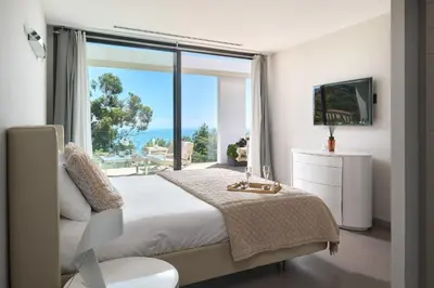 a living room with a white couch and a glass table at Villa Baie Des Iles in Cannes