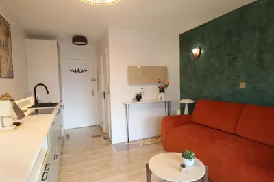 an empty hallway with plants and white cabinets at Volt ' palm in Cannes