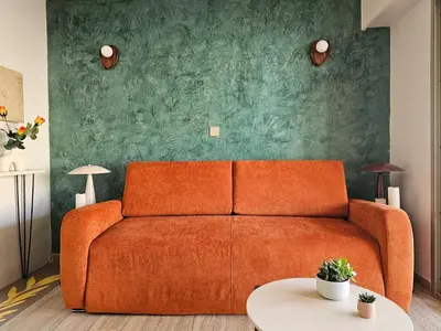 a living room with a chair and two tables at Volt ' palm in Cannes