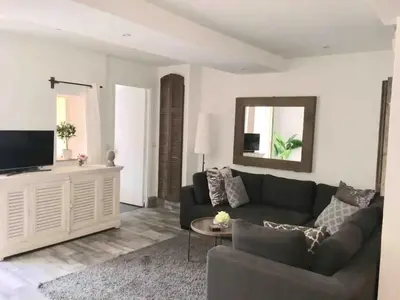 a living room with a couch and a television at Cannes Centre Old Town 5 Pers 2 Bedroom in Cannes