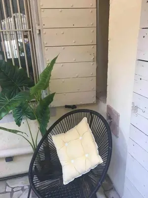 a pillow sitting on a table on a porch at Cannes Centre Old Town 5 Pers 2 Bedroom in Cannes