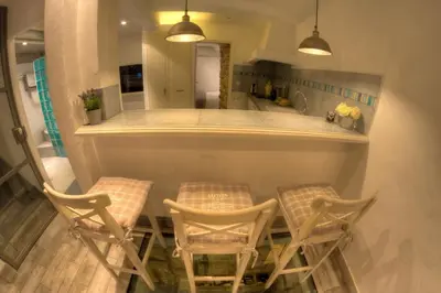 a kitchen with two chairs and a table and a counter at Cannes Centre Old Town 5 Pers 2 Bedroom in Cannes