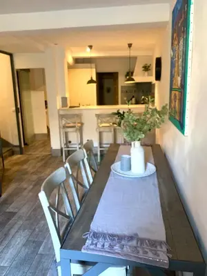 a dining room table with chairs and a vase on it at Cannes Centre Old Town 5 Pers 2 Bedroom in Cannes