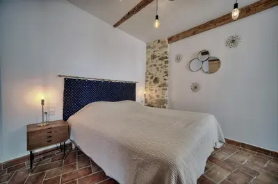 a bedroom with a bed and a table and a window at Agréable Studio quartier Suquet-Vieux Port A0B185 in Cannes