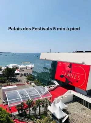 a building on the beach with a coca cola sign at Agréable Studio quartier Suquet-Vieux Port A0B185 in Cannes