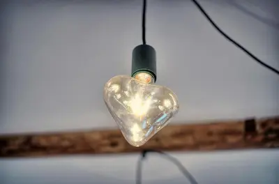 a glass heart shaped light bulb hanging from a ceiling at Agréable Studio quartier Suquet-Vieux Port A0B185 in Cannes