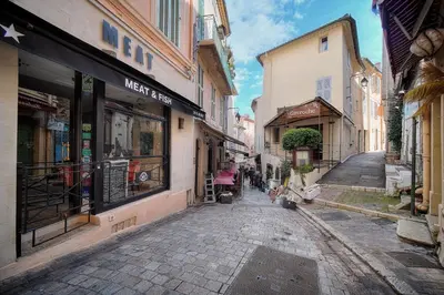 an empty street in an old town with shops at Agréable Studio quartier Suquet-Vieux Port A0B185 in Cannes