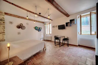 a bedroom with a bed and a table in it at Agréable Studio quartier Suquet-Vieux Port A0B185 in Cannes