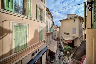 an alley with buildings and people walking on the street at Agréable Studio quartier Suquet-Vieux Port A0B185 in Cannes