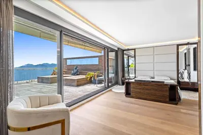 a living room with a view of the ocean at REF 2043 - Cannes Penthouse with panoramic sea view for rent in Cannes