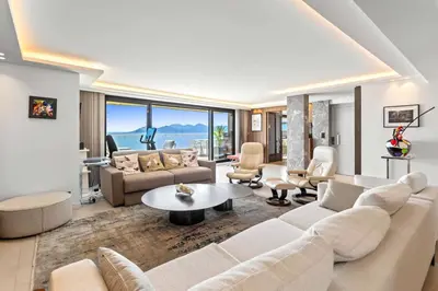 a living room with a couch and a table at REF 2043 - Cannes Penthouse with panoramic sea view for rent in Cannes