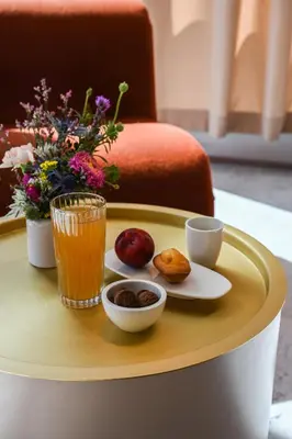 a table with a tray with food and drinks on it at OKKO Hotels Cannes Centre in Cannes