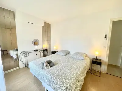 a bedroom with a large bed in a room at Cannes Center by Welcome to Cannes in Cannes