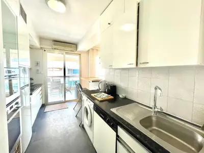 a kitchen with a sink and a counter top at Cannes Center by Welcome to Cannes in Cannes