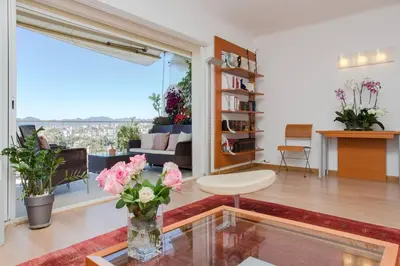 a living room with a vase of flowers on a table at Appartement chic à Cannes, avec terrasse et cheminée, 83 m² in Cannes