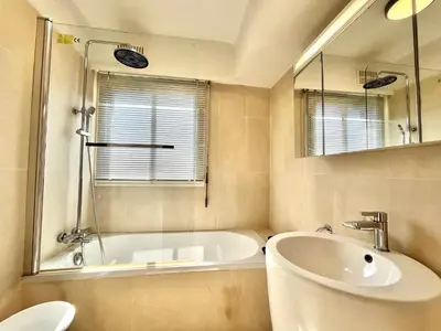 a bathroom with a tub and a sink and a mirror at Méditerranée by Welcome to Cannes in Cannes