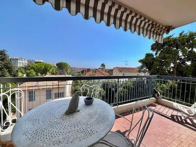 a table and chairs on a balcony with a view at Méditerranée by Welcome to Cannes in Cannes