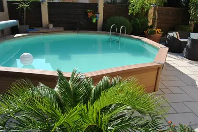 a large swimming pool in a yard with plants at Le Calme au Centre Ville à 10 minutes à pied de la Croisette et des plages in Cannes