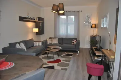a living room with a couch and a table at Le Calme au Centre Ville à 10 minutes à pied de la Croisette et des plages in Cannes