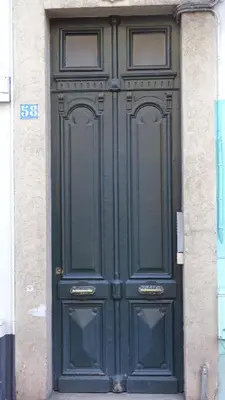 a large green door on the side of a building at Appartement Loft Cannes in Cannes