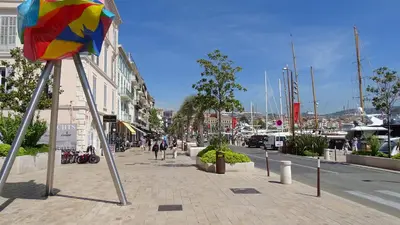 a street with a colorful flag on a sidewalk at Appartement Loft Cannes in Cannes
