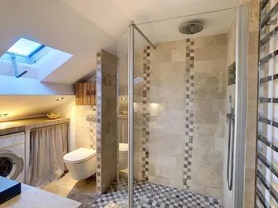 a bathroom with a shower with a toilet and a sink at Appartement Loft Cannes in Cannes