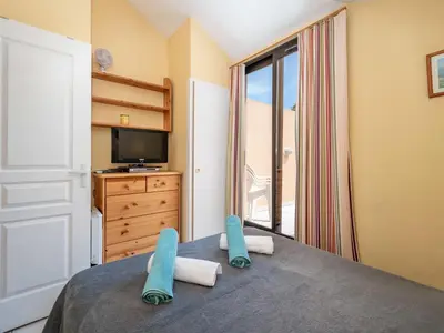 a bedroom with a bed with two slippers on it at Apartment Villa Francia-5 by Interhome in Cannes