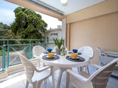 a white table and chairs on a balcony at Apartment Villa Francia-5 by Interhome in Cannes