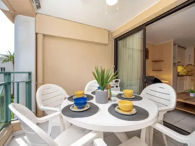 a white dining room with a white table and chairs at Apartment Villa Francia-5 by Interhome in Cannes