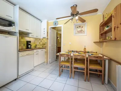 a kitchen with a table and a ceiling fan at Apartment Villa Francia-5 by Interhome in Cannes