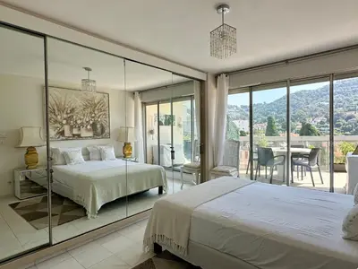 a bedroom with two beds and a glass wall at CANNES CROISETTE Sea & Sky in Cannes