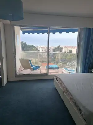 a bedroom with a bed and a balcony with a view at CANNES CROISETTE Sea & Sky in Cannes