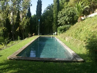 a swimming pool in the middle of a grass field at Scenic villa in Cannes with private pool in Cannes