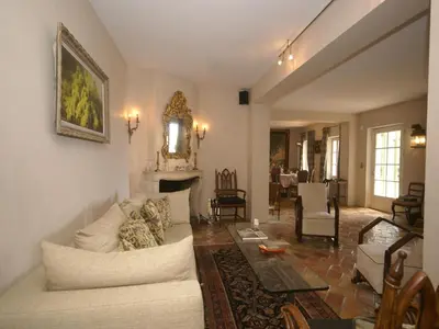 a living room with a white couch and a table at Scenic villa in Cannes with private pool in Cannes