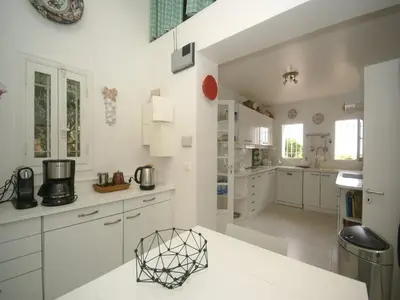 a kitchen with white cabinets and a white counter top at Scenic villa in Cannes with private pool in Cannes