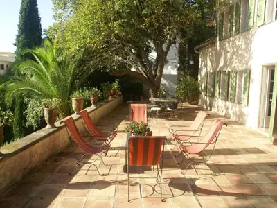 a row of chairs and tables on a patio at Scenic villa in Cannes with private pool in Cannes