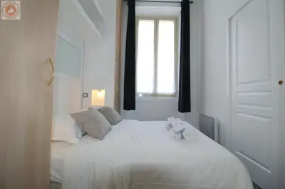 a white bed in a room with a window at ALC - MOL6 - 9 min Palais and 5 min Beaches in Cannes
