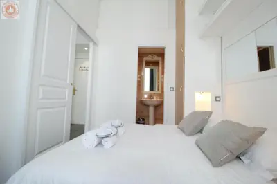 a bedroom with a white bed with two mugs on it at ALC - MOL6 - 9 min Palais and 5 min Beaches in Cannes